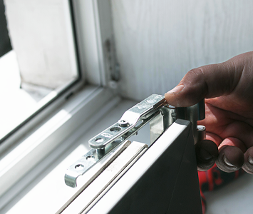 Locksmith repairing the mechanism on a uPVC door
